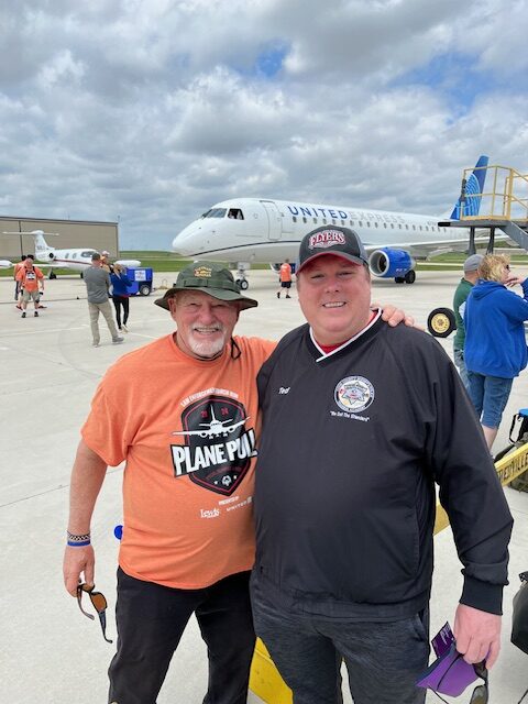 Two Plane Pull event participants standing together posing for a photo