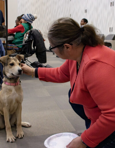 TAILS OF REDEMPTION DOG, STORM, GETTING PETTED BY GOV. STATE STUDENT