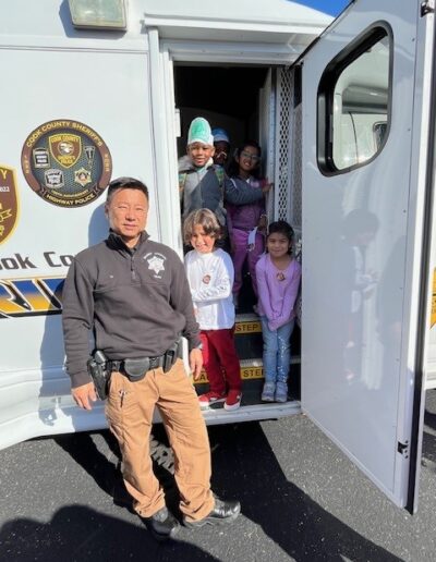 Officer and children at Apollo Partners Day