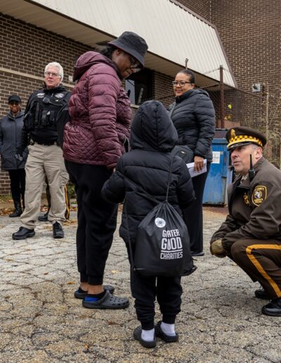 Officer speaking with participant at Thanksgiving Turkey Giveaway