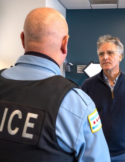 Sheriff Dart speaking with an Officer at the Senior Law Enforcement Graduation in Bedford Park