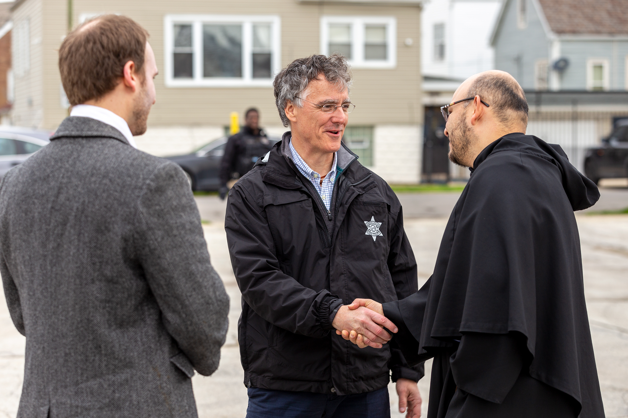 Sheriff Tom Dart shaking the hand of a community member